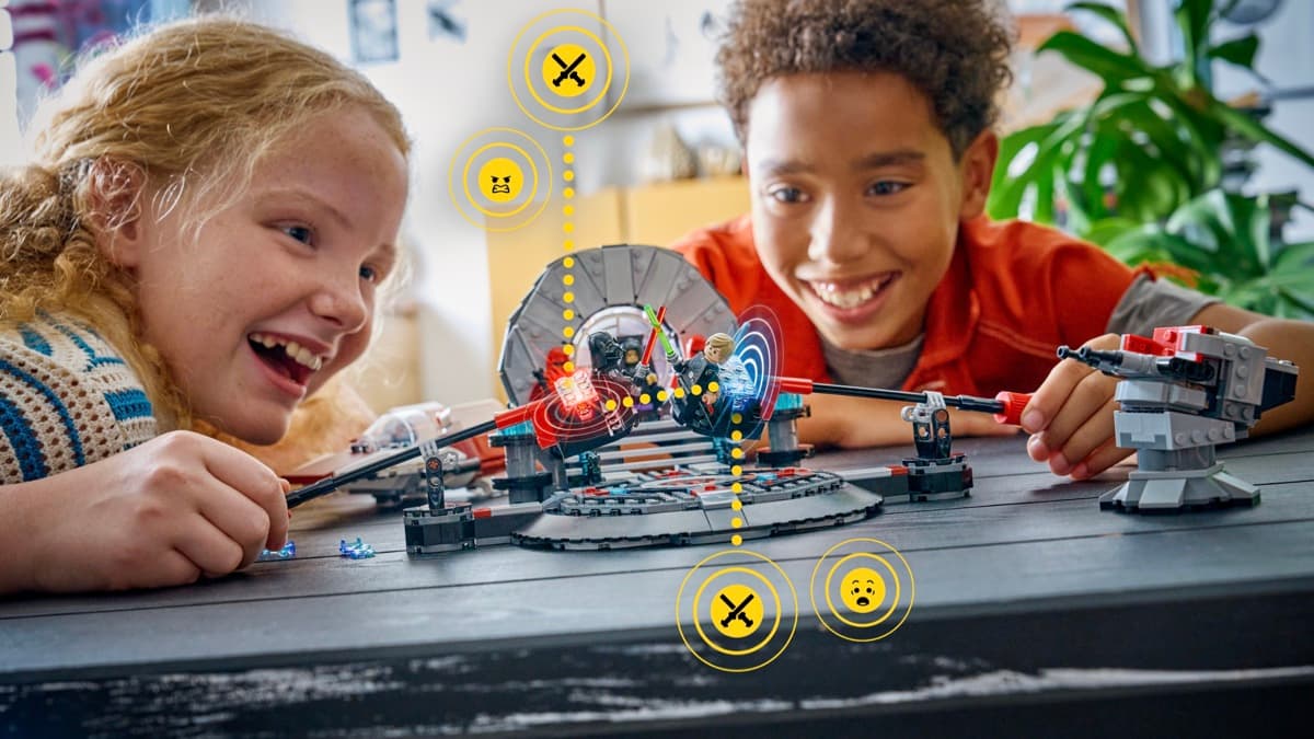 Two children playing with LEGO Smart Play Throne Room Duel set, with SMART Brick icons showing interactive reactions