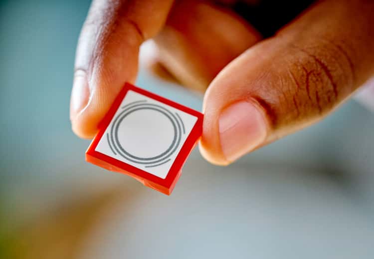 Close-up of a red LEGO SMART Tag with circular pattern